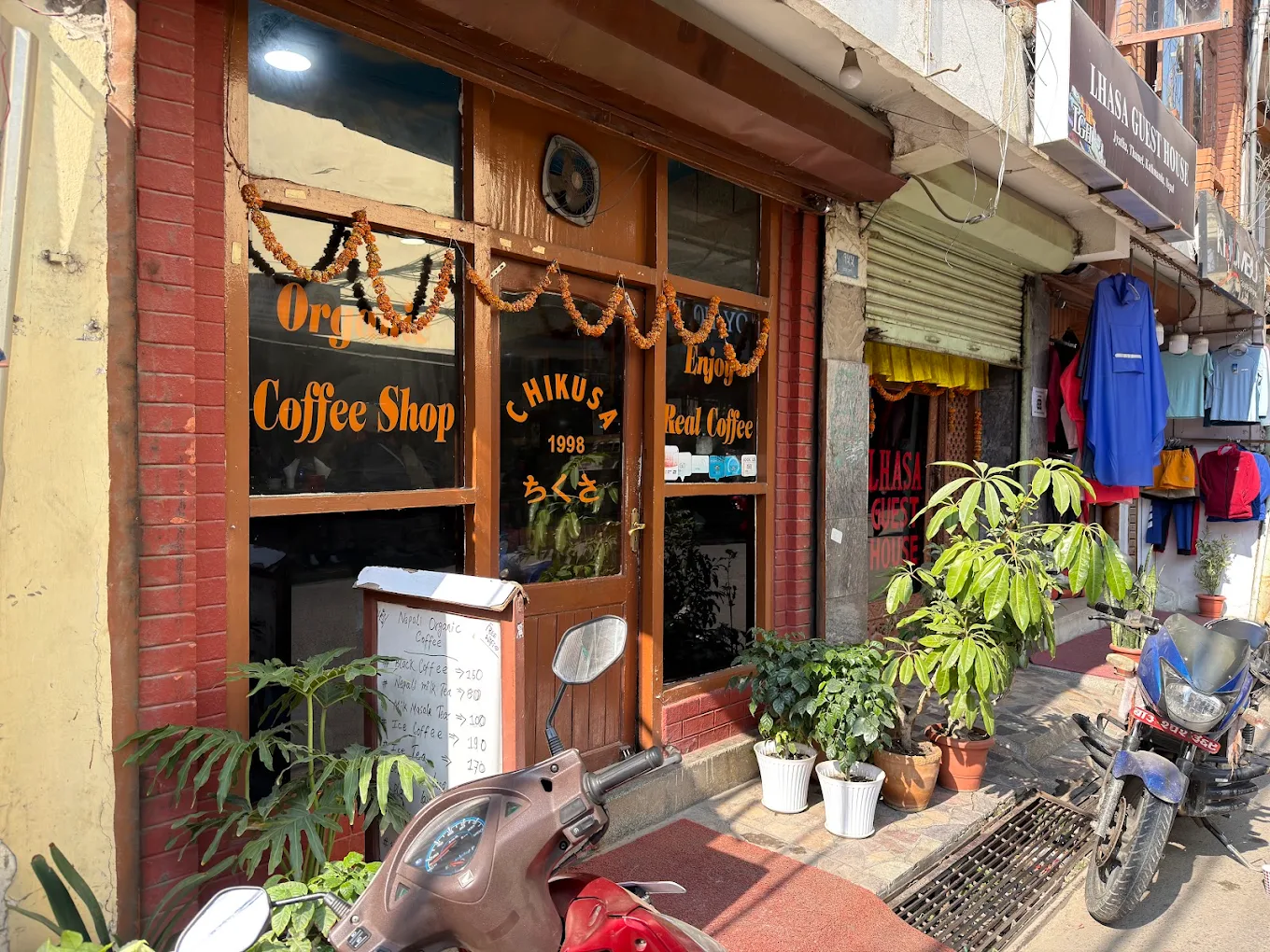 Chikusa Coffee Shop storefront in Jyatha, Thamel, with “Organic Coffee Shop” and “Enjoy Real Coffee” painted on the windows